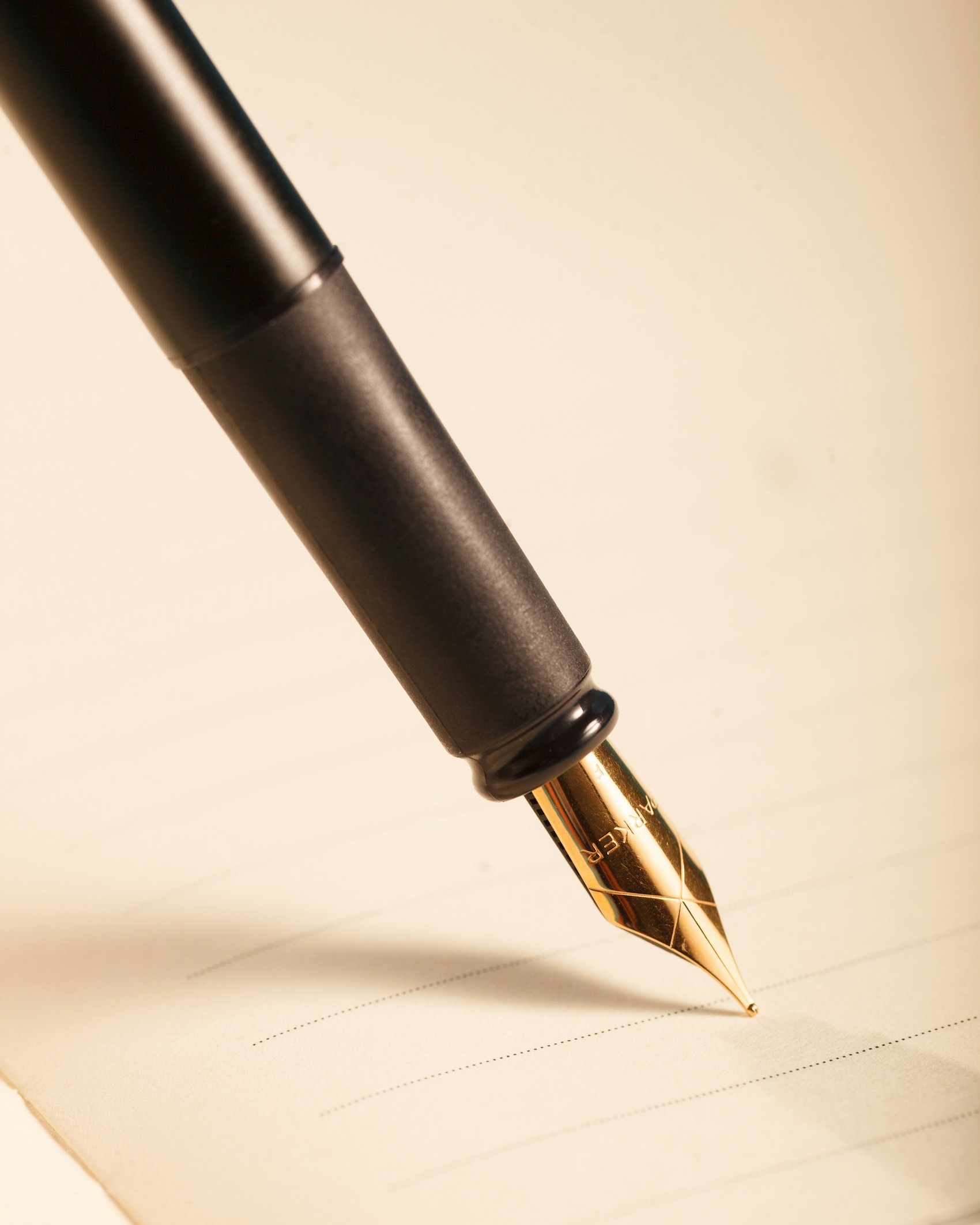 A fountain pen with a gold nib resting on paper, ready to write a Will